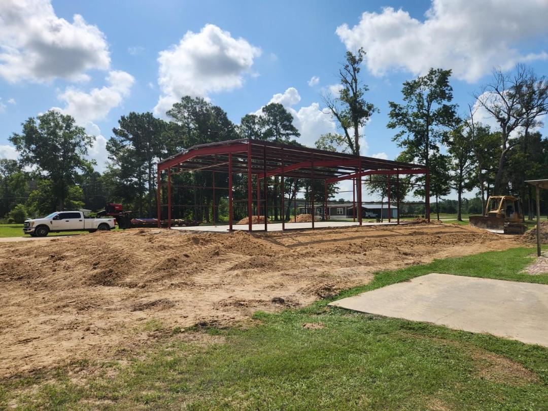 Structural steel beam and column delivery and crane set on residential new construction project near Houston